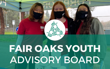 FOYAB - image of three volunteers standing under tent