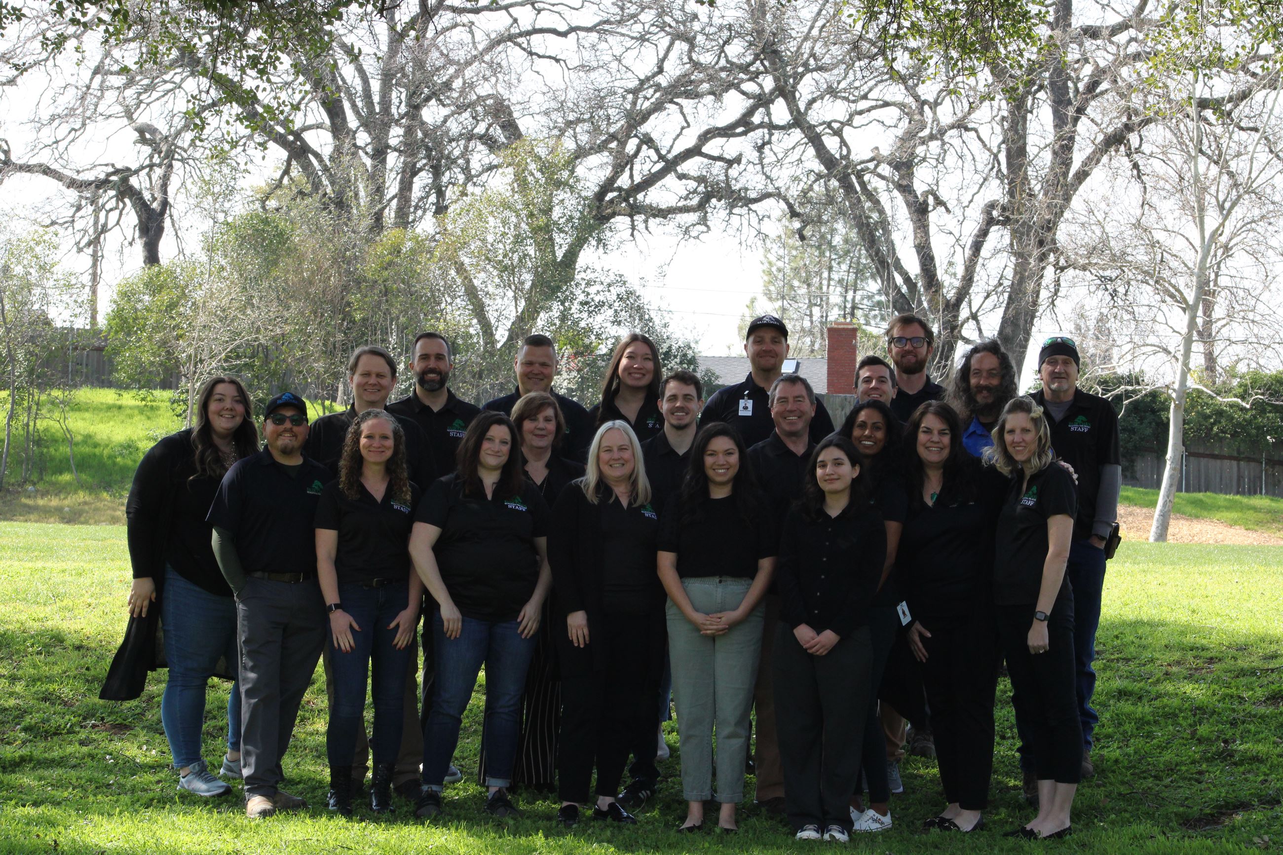 Photo of full FORPD staff standing in park